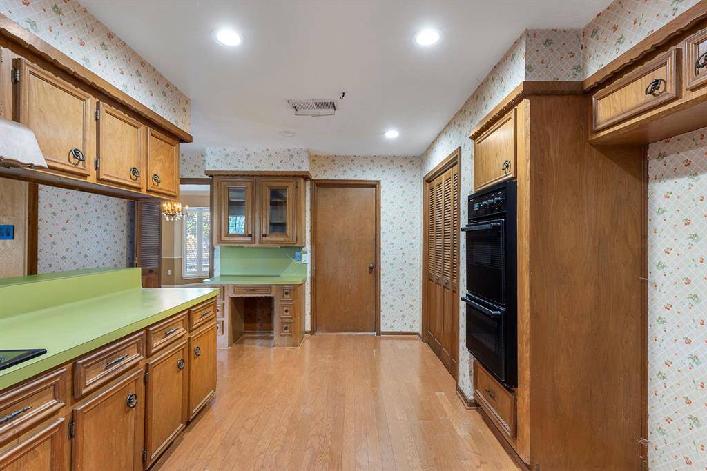 The kitchen has a built-in workspace and overhead cabinetry.