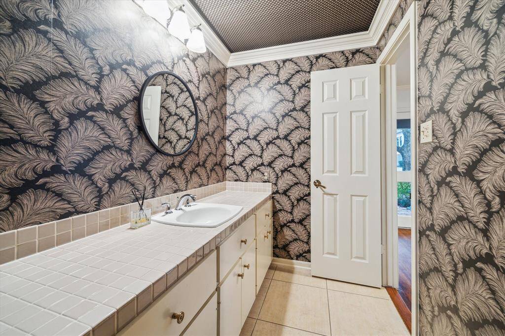 [Powder Bath] Positioned in the entry hall -  well-appointed powder room with ample conter space and storage.