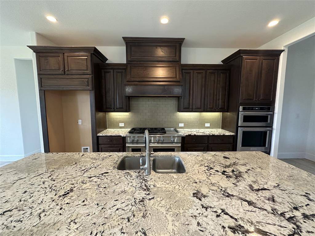 Kitchen Island with sink and stove and under Cabinet lighting