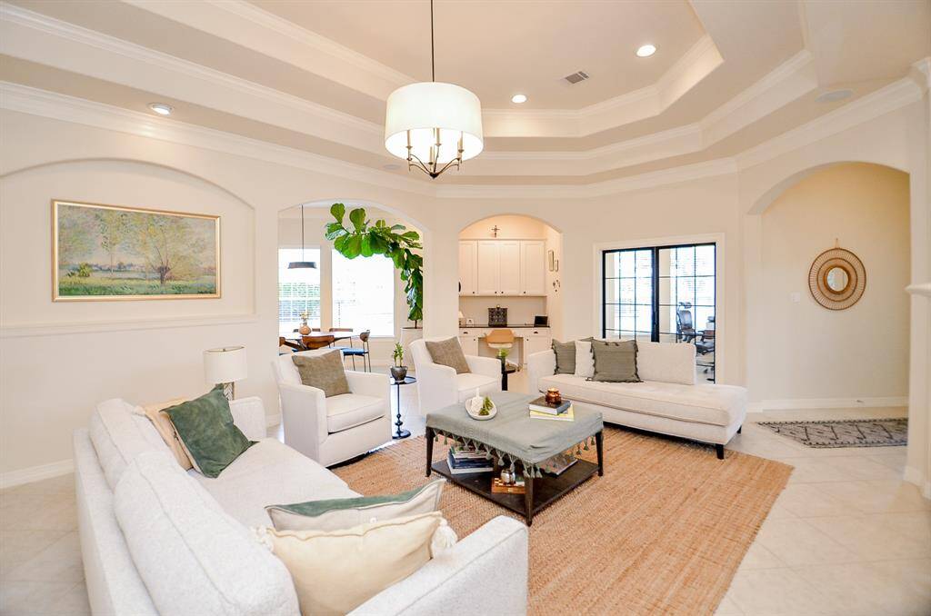 From this view, you can see the home office with its glass doors as well as the secondary desk space, inset it its own niche.  Two people can work comfortably from home and have their own designated space.