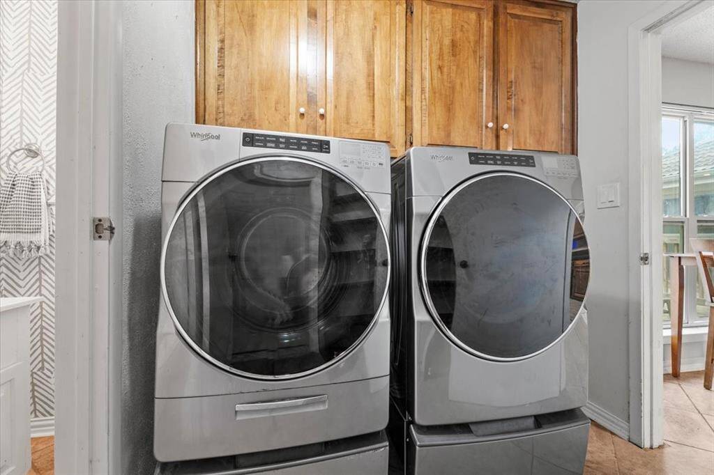 The utility room is located off of the kitchen and has garage access.
