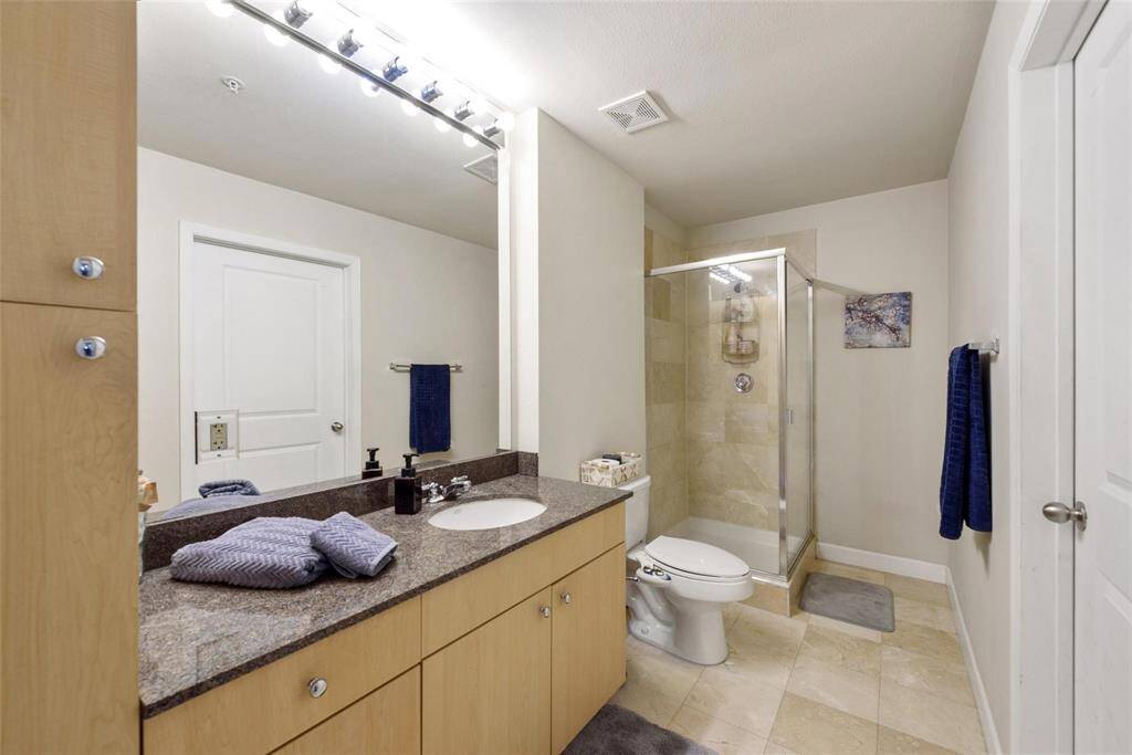 The large full bath has ample cabinets for linens and bath necessities.