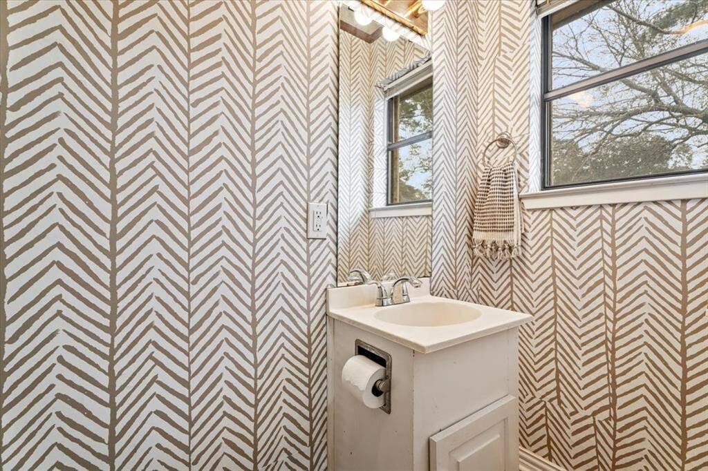 The half bath is located next to the utility room.