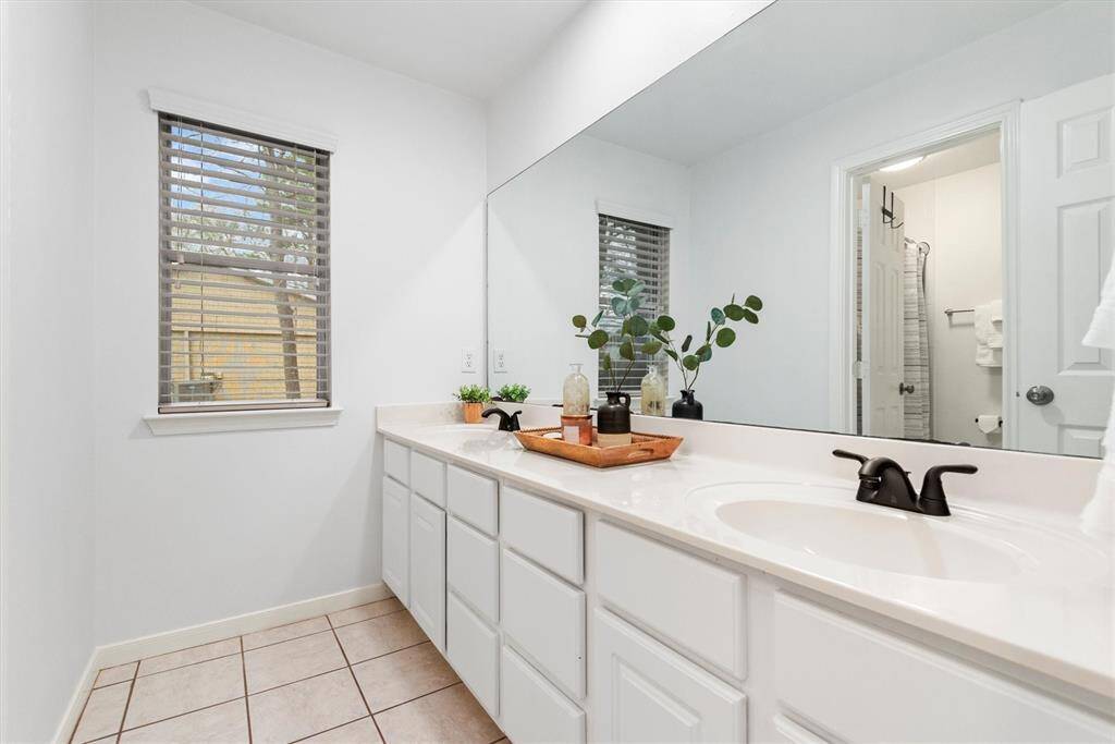 The shared secondary bathroom is conveniently located between the 2 bedrooms but is also easily accessible from the common areas of the home for guests. The vanity area is separated from the tub and toilet area by a door making this bathroom easy to use by more than one at a time.  It's perfect as a shared bathroom for kids.