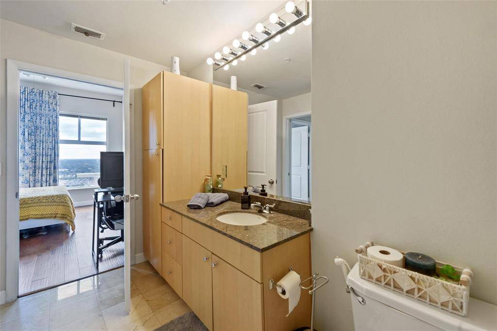 A view of the secondary bedroom from the bathroom.