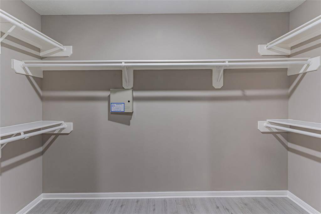 Expansive walk-in closet in the primary bath, offering ample storage and organization space.