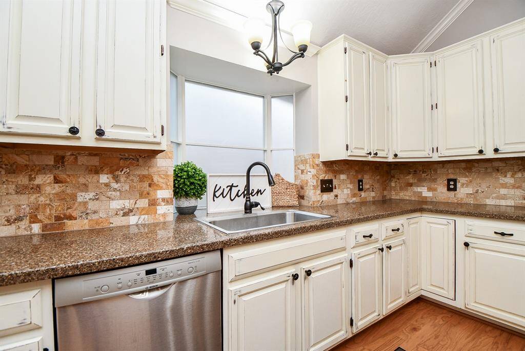 Large kitchen window behind sink.