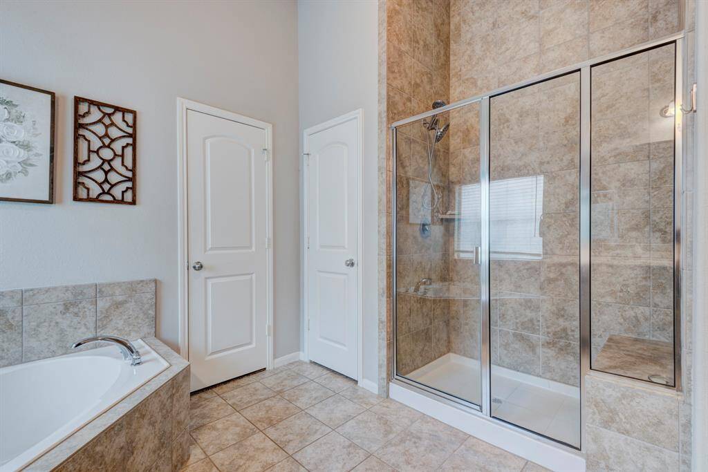 Oversized separate shower with tile backsplash.