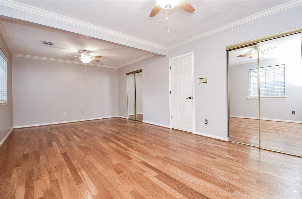 Huge secondary bedroom with 2 ceiling fans and 2 closets.