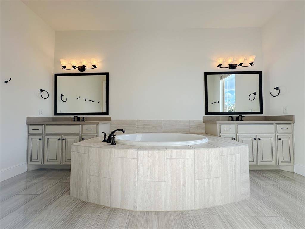 Primary bathroom soaking tub and sinks.