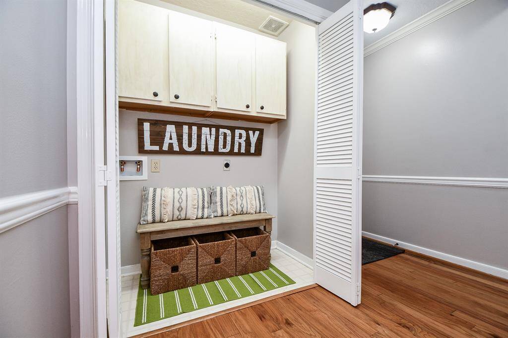 Laundry area with built-in cabinets.