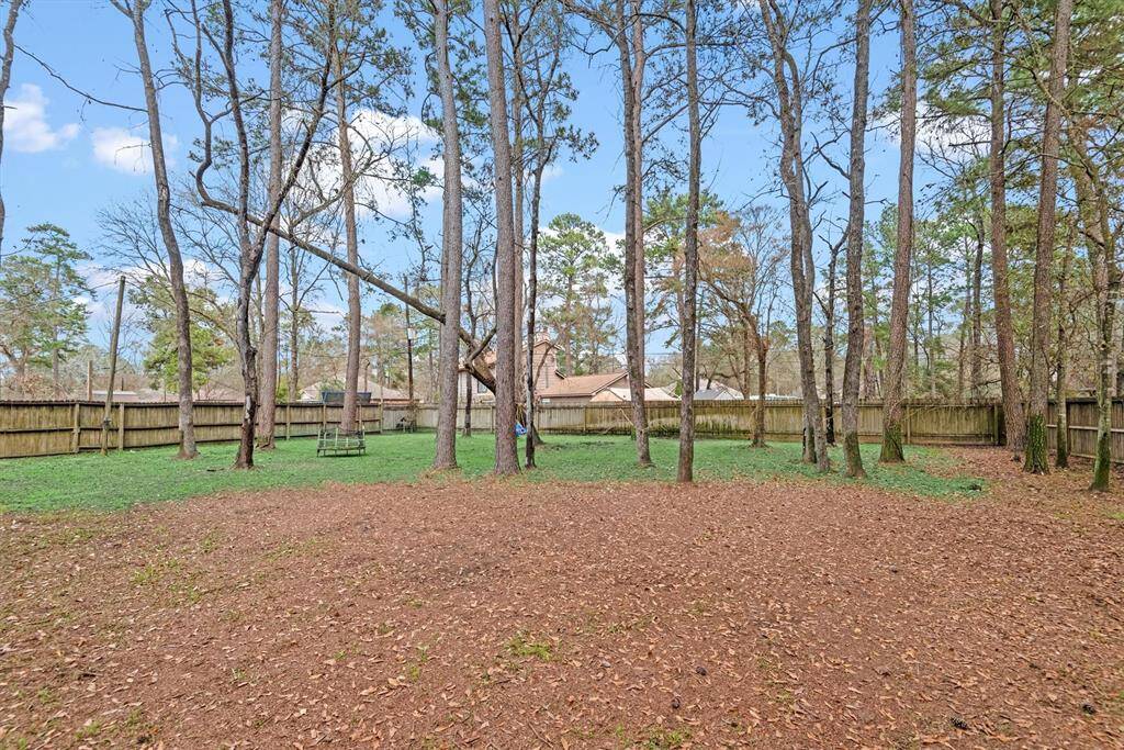 Step outside to a HUGE backyard—plenty of space for play and entertaining. This oversized outdoor retreat offers endless possibilities for relaxation and fun.  It's hard to find a 20K SF lot in the heart of Magnolia.  What does your dream backyard look like? Come build it here!