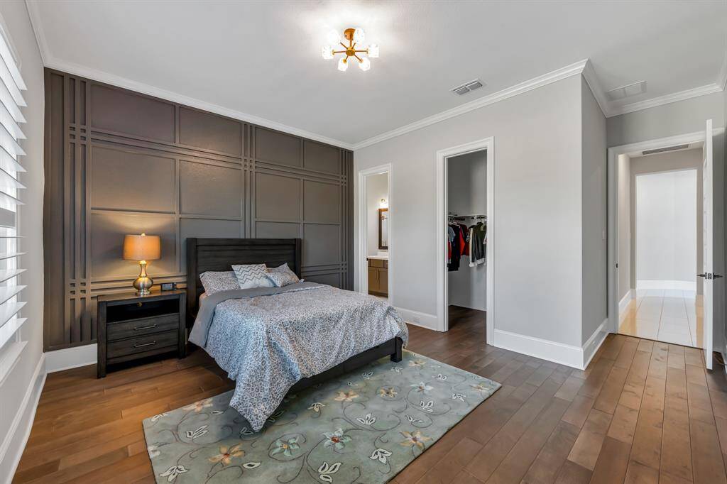 Secondary bedroom featuring elegant textured walls with en-suite bathroom
