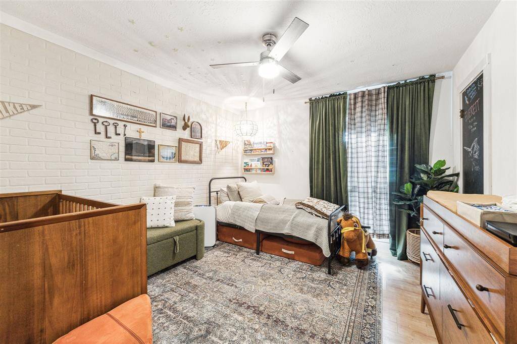 Currently this bedroom is a child's bedroom/nursery. Nice sized walk-in closet. Decorative faux brick wall accents the room.