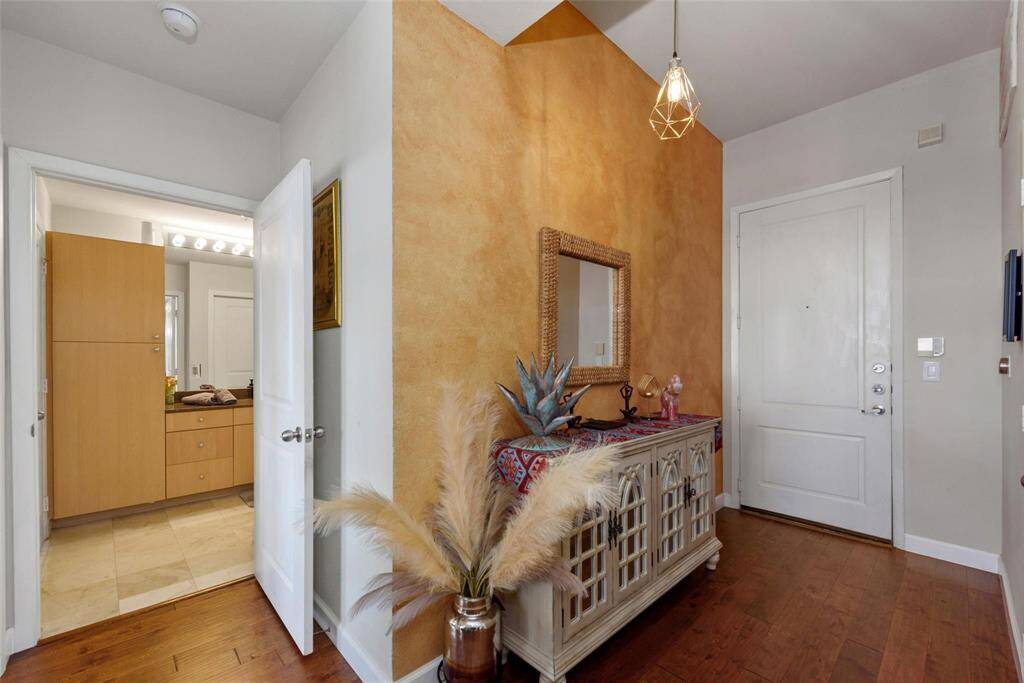 The entryway to the unit is open and leads to the living, dining, and kitchen.