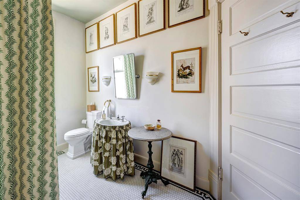 The secondary bath features stunning hex tile flooring, adding a touch of modern elegance to the space and tub shower combo.