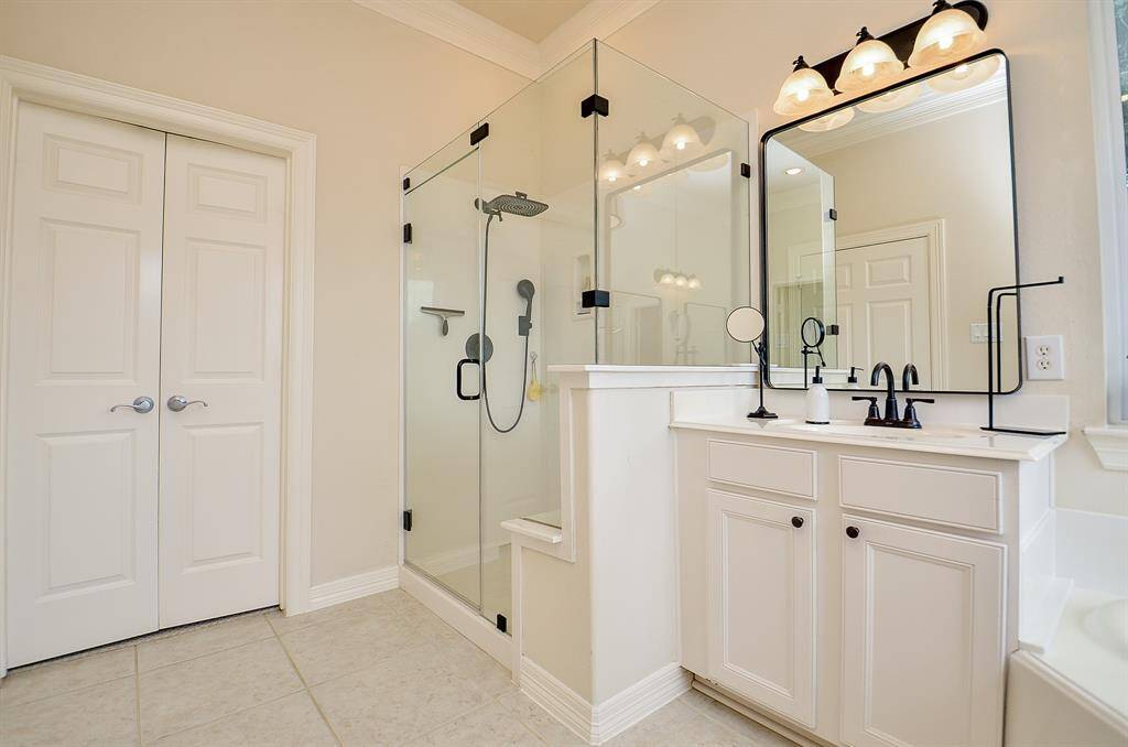 New frameless shower door (2024), new rain shower head and wand as well as a shower seat make this shower accessible for a variety of needs.