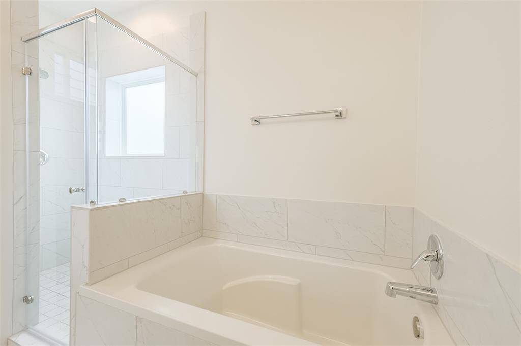 Primary soaking tub and separate shower.