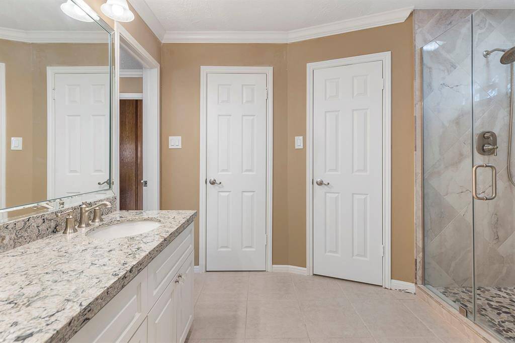 Relax in the modern walk-in shower with seamless glass enclosure.