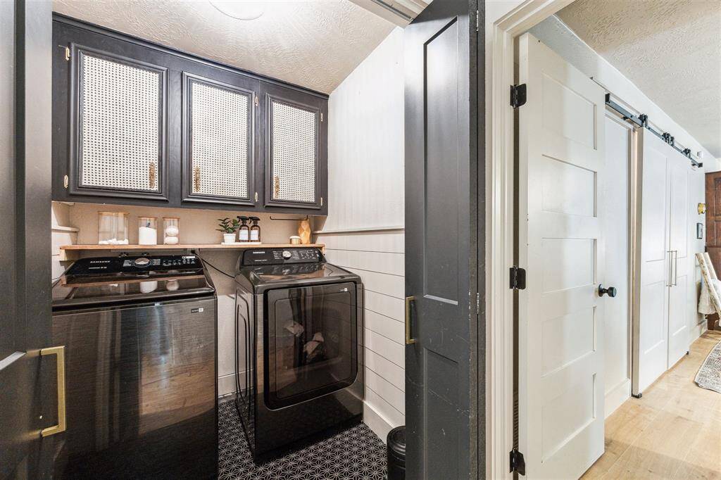 Laundry room with cabinetry. Even this space has the custom flare to it!