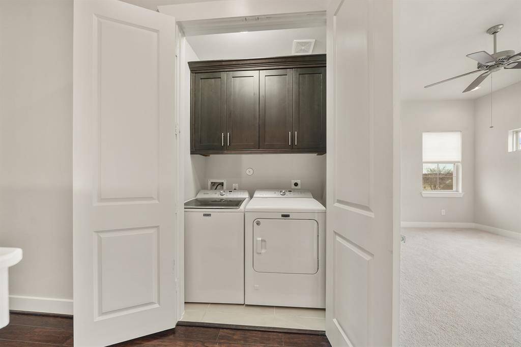 Conveniently accessible from the owner's suite & secondary bedroom is the utility room with upper cabinet storage, full-size washer and dryer & tile flooring.
