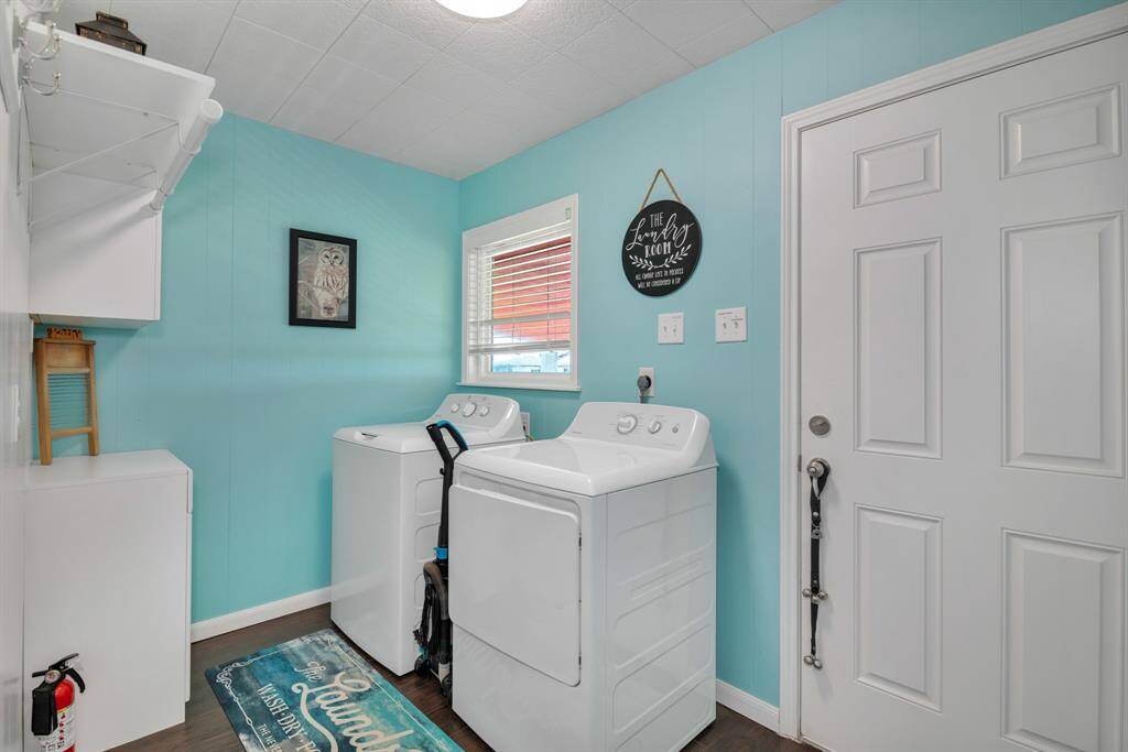 Generous utility room with door leading to the back deck.