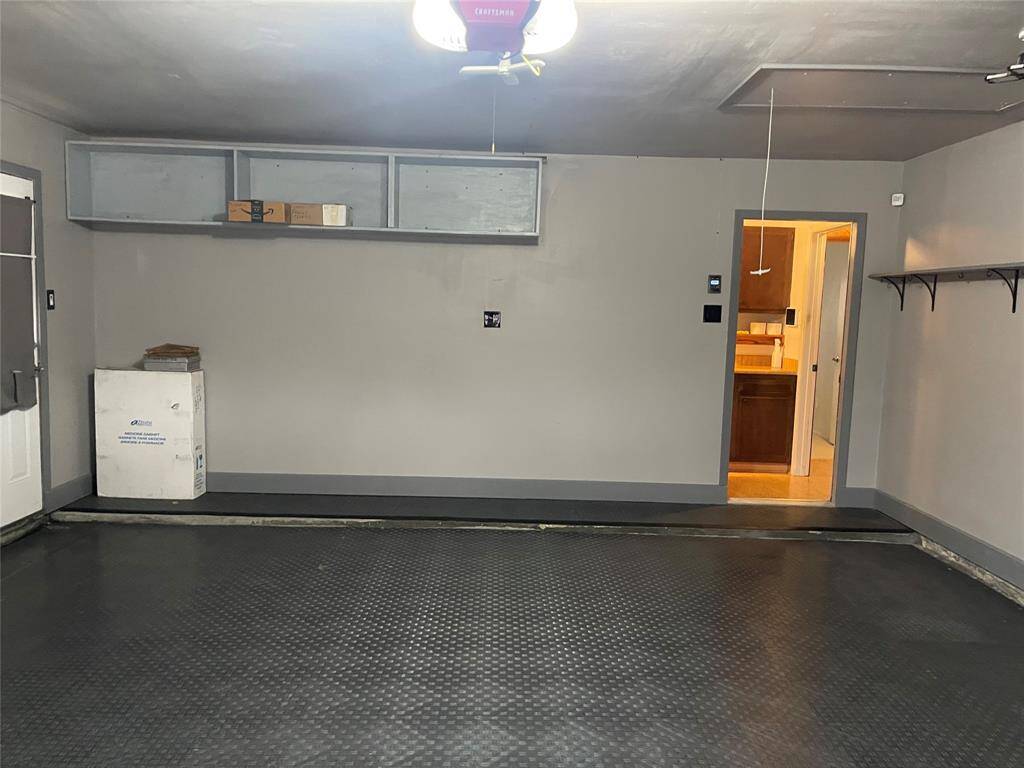 Garage has been remodeled.  New flooring, fresh paint, garage door opener, attic ladder, shelving and insulation.