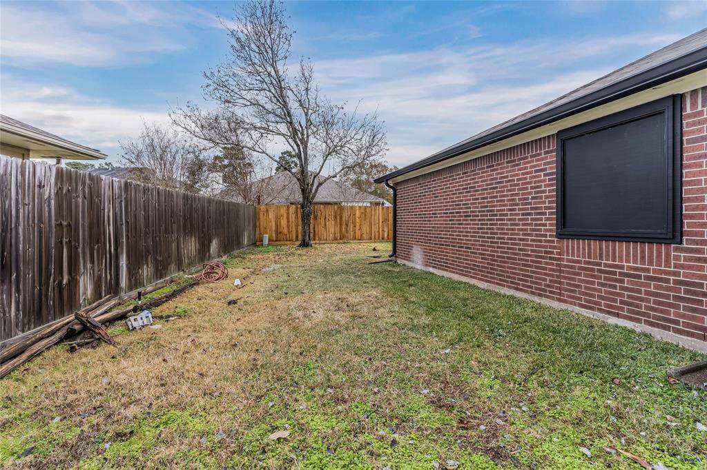 Charming side yard with convenient gate access, perfect for easy outdoor living and privacy.
