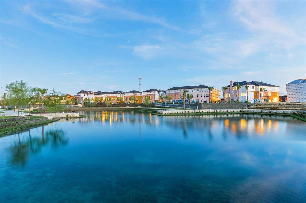gorgeous community lake with walking trails and picnic tables inside oasis gated community