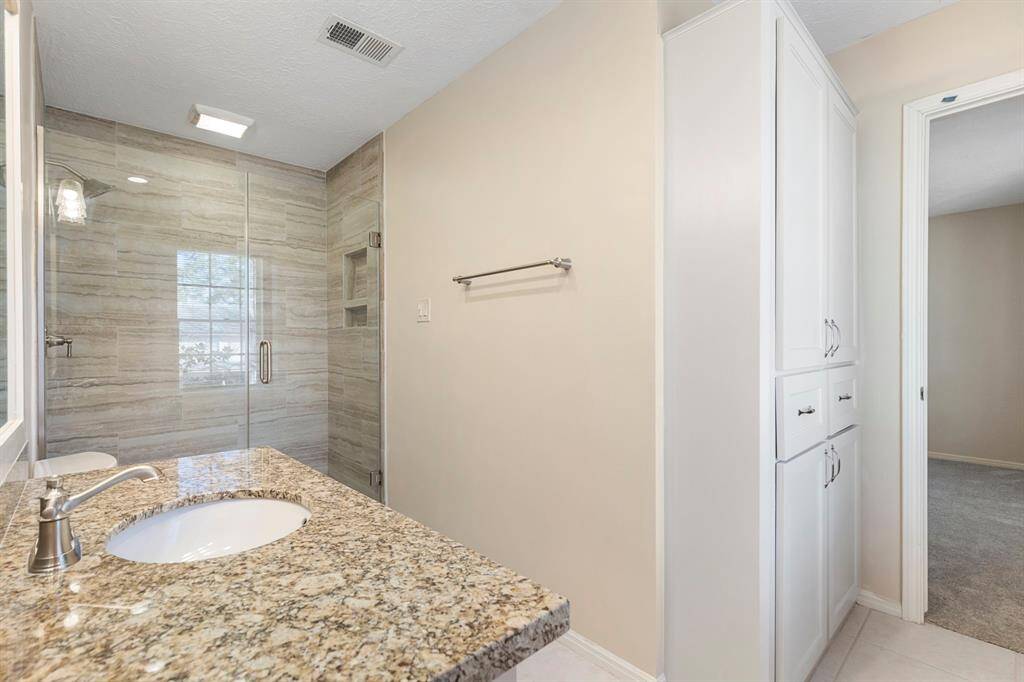 This updated full-size bath is shared with secondary bedrooms #1 and #2 with new tile, decorative mirror, huge shower and granite vanity with brushed chrome fixtures.