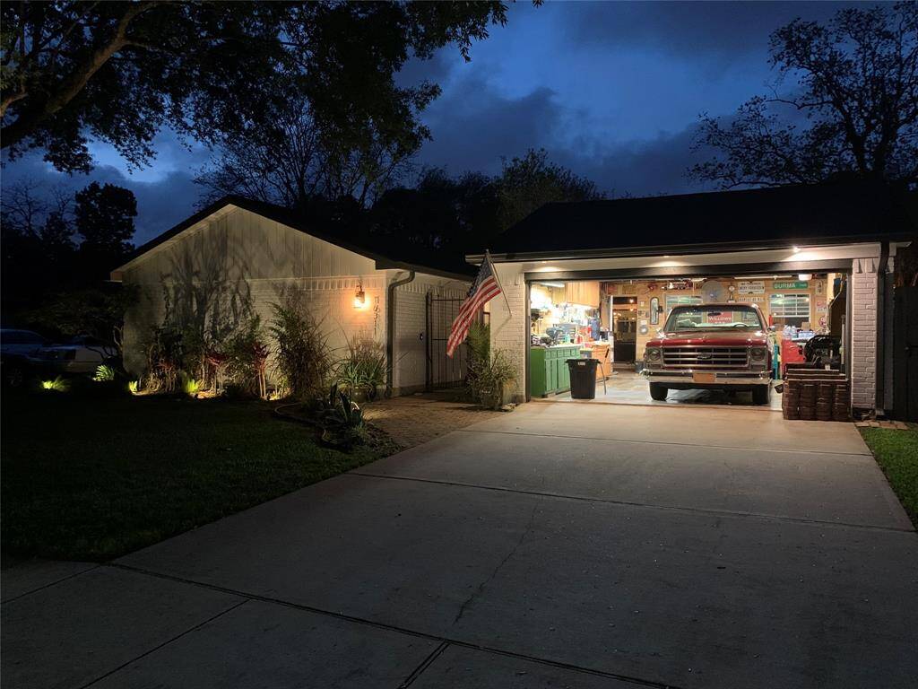 Landscape lightning and newly remodeled garage that include windows for light and a breeze.