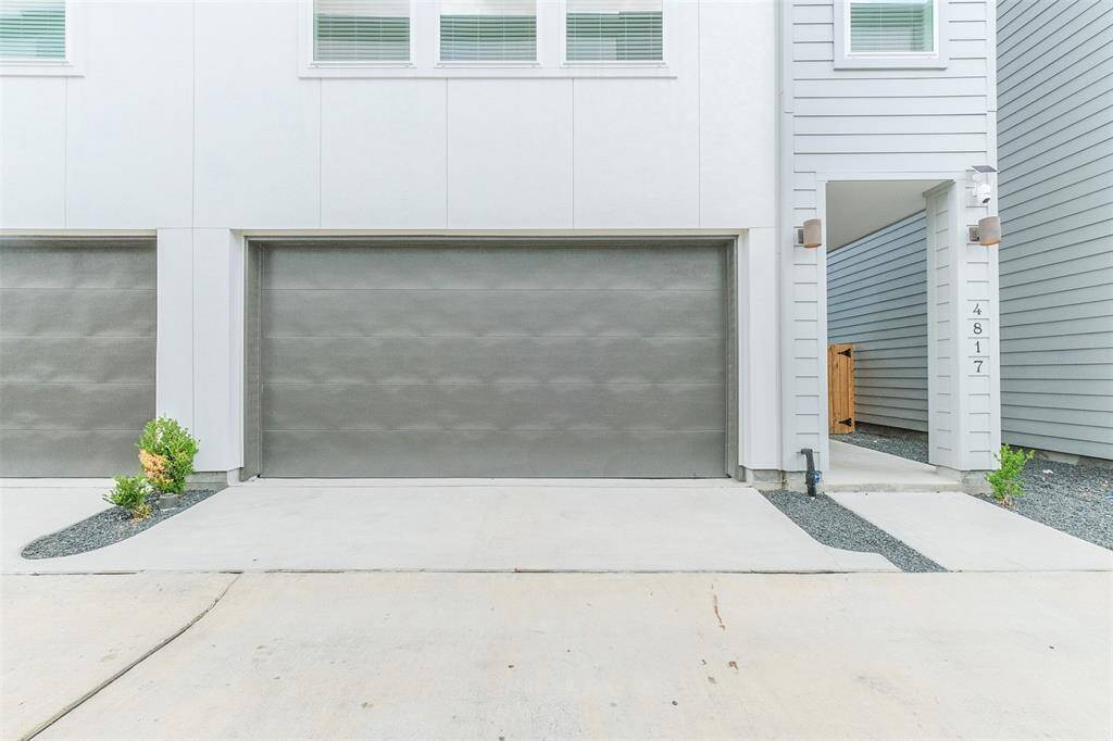 The garage door itself is a stylish and sturdy feature, showcasing a blend of durable materials and elegant craftsmanship. Its smooth operation and secure locking mechanism provide both convenience and peace of mind.