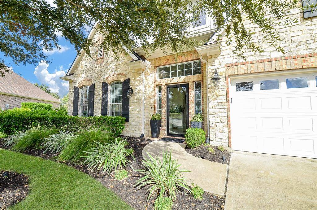 A glass storm door fills the hallway with sunshine and the gutters direct the rain away from of the foundation of the house.
