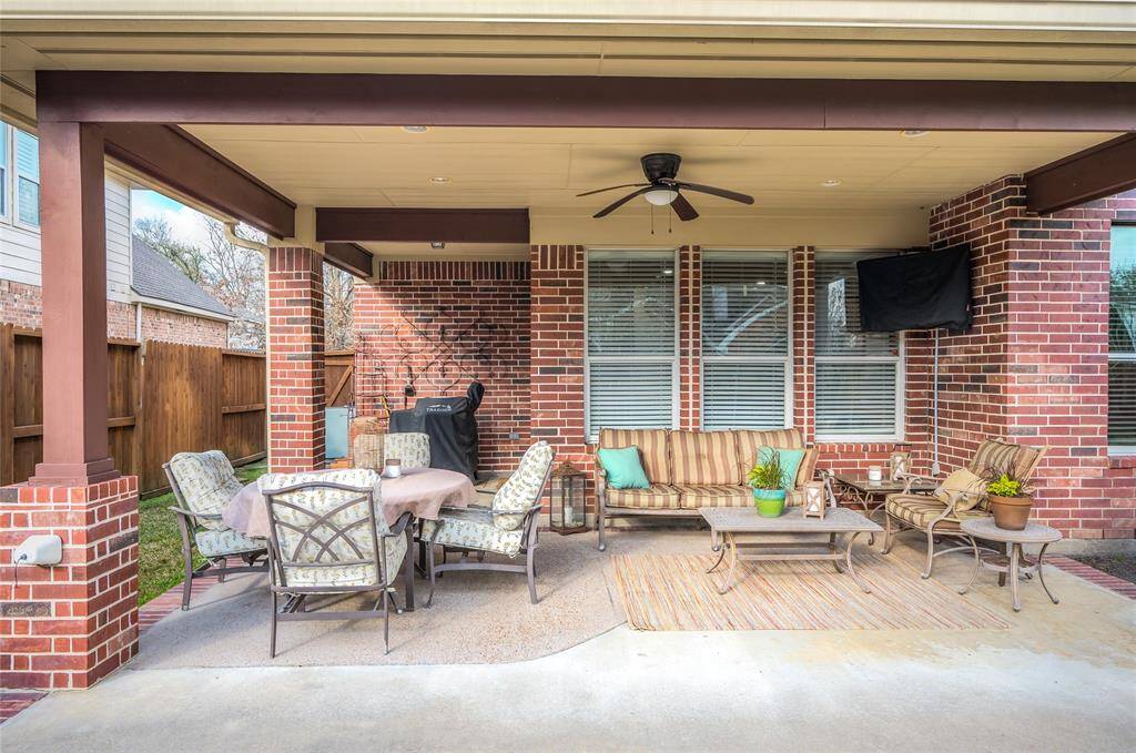 Inviting covered back porch for entertaining.
