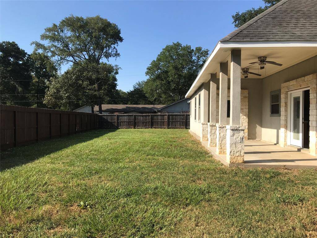 The backyard is HUGE with a nice covered patio. The property goes around the 3 sides of the home.