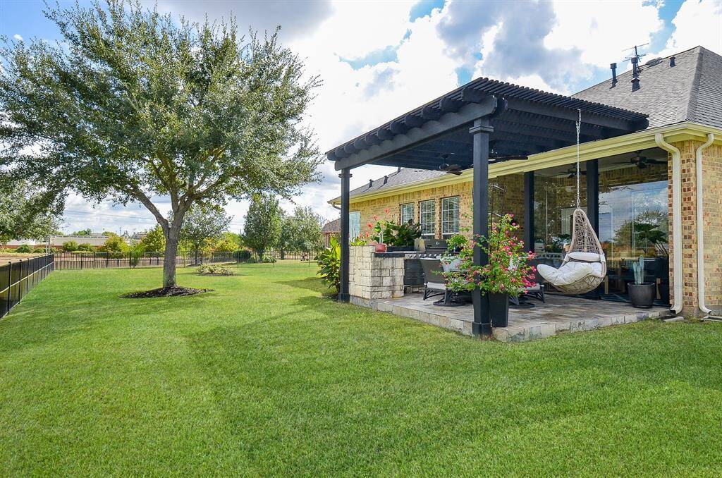 Here is a view of the entire patio area with the lovely pergola, hanging chair and outdoor dining space.  What wonderful parties you can have!