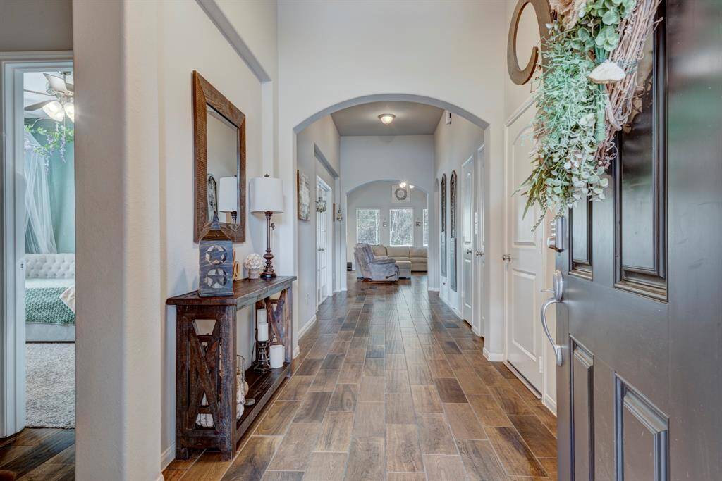 As you walk into the home you will be greeted with an oversized foyar. Secondary bedrooms and bathroom are to the left.