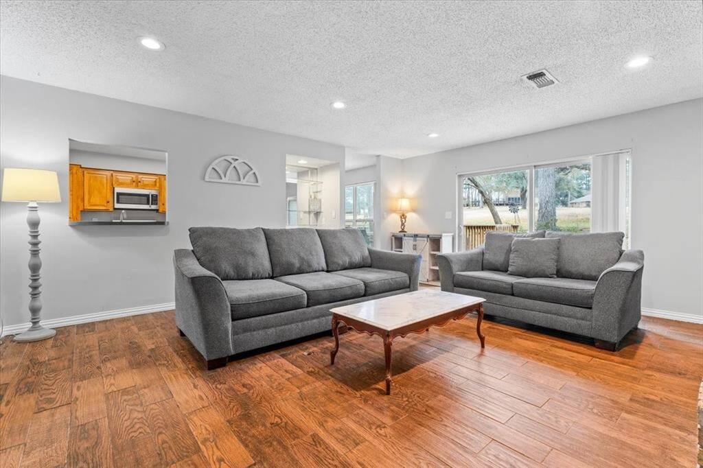 Bright and spacious living room with views to The Lakes golf course.