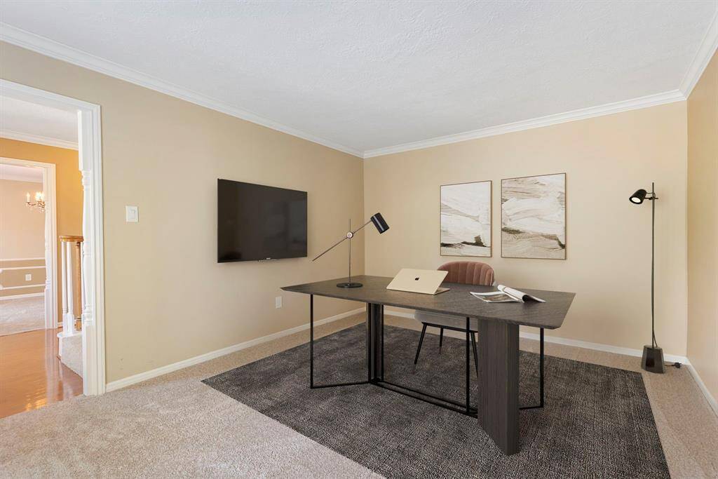 The separate dining room is to the left of the entry with new carpet, chair moulding and access to the kitchen. *This image has been virtually staged.