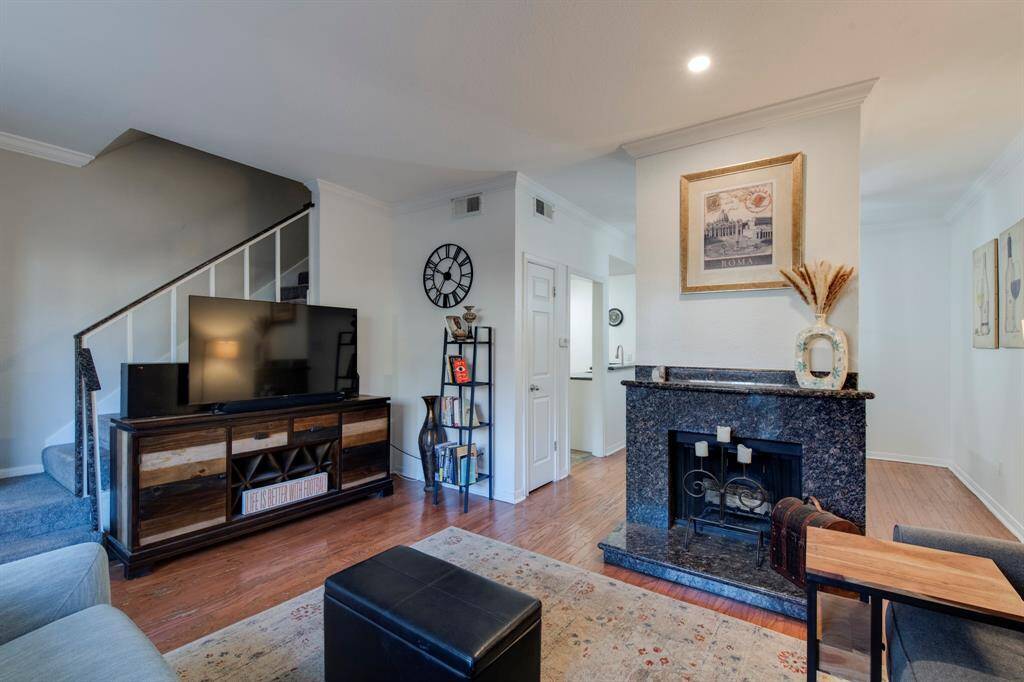 Living room has engineered hardwoods, and large sliding glass door that lets in a lot of natural light. Powder room to the right of the front door.
