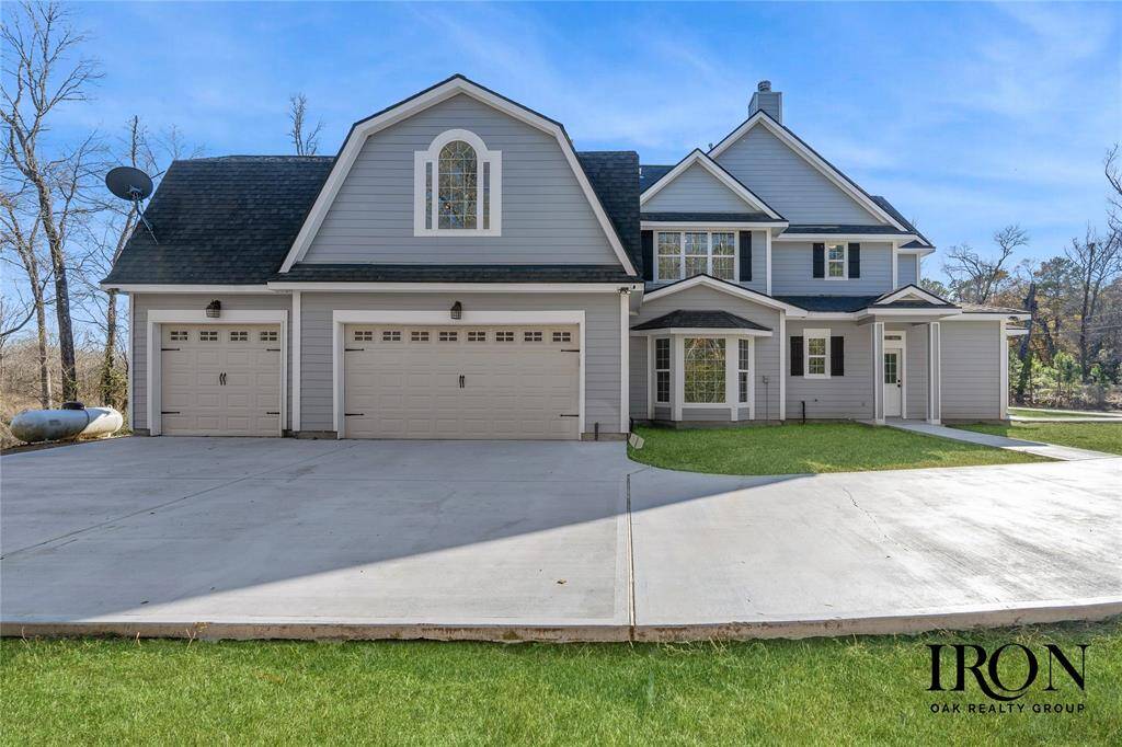 Three-Car Garage with a convenient exterior entrance leading directly to the mudroom. Grass has been virtually enhanced.