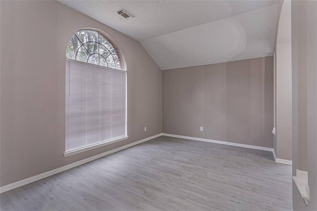Elegant living room with a grand entryway and plenty of natural light.