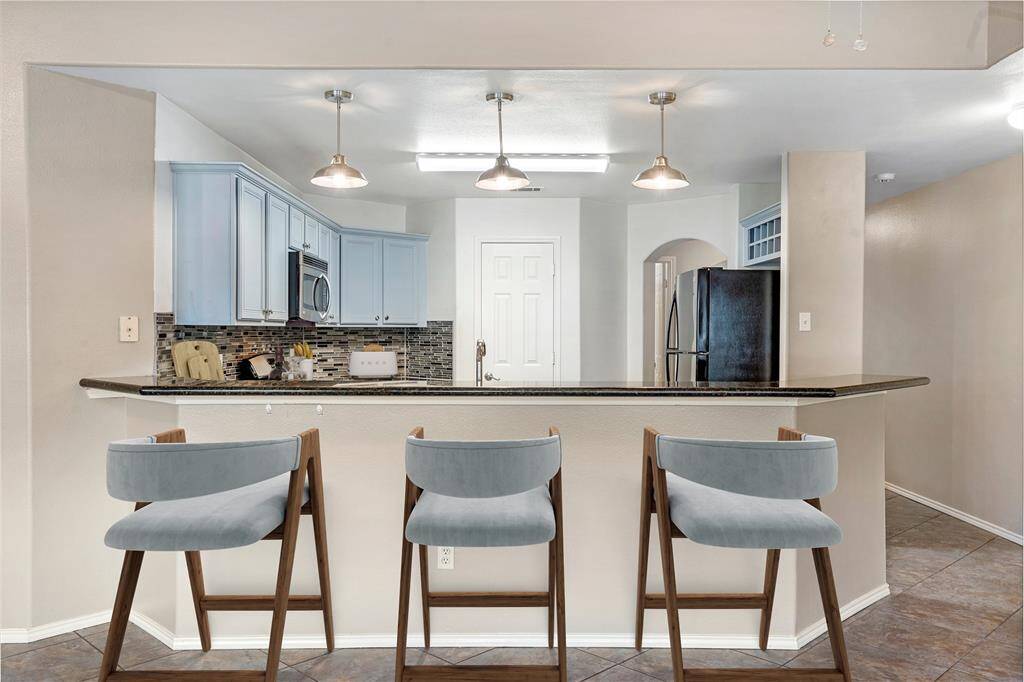 A breakfast bar offers a place for those not helping in the kitchen to relax and still enjoy the chef's company. THE REFRIGERATOR STAYS!