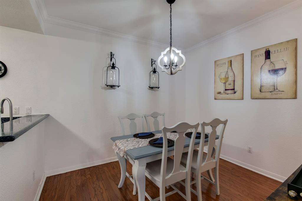 Living room has granite surround fireplace that frames the room and separates the living from the dining room.
