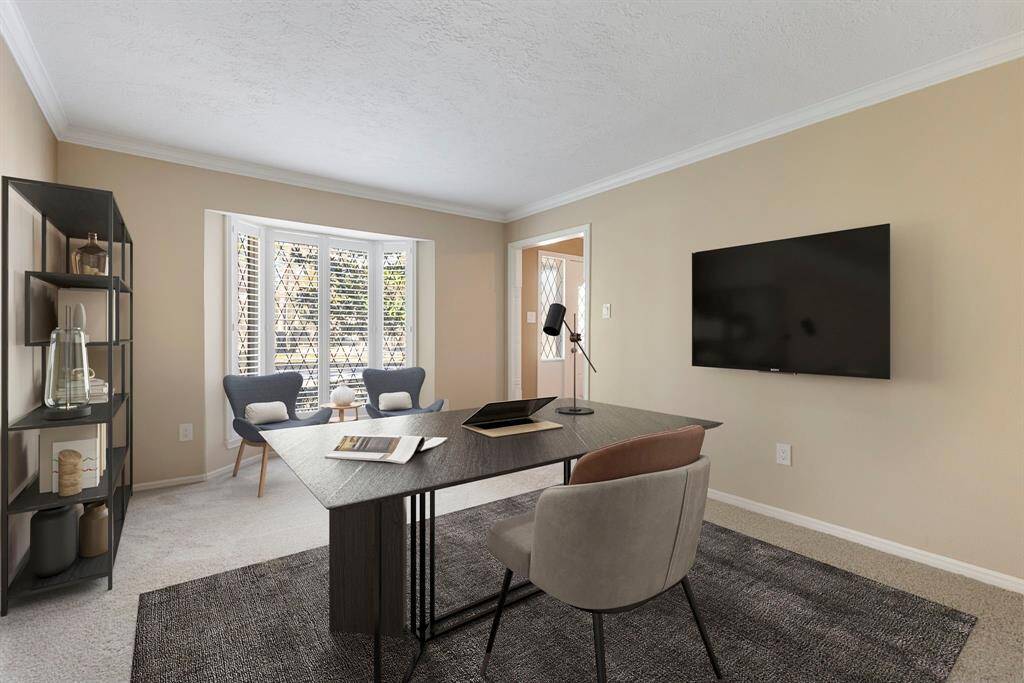 To the right of the entry, you will find a large room—perfect for a study or additional sitting room. *This image has been virtually staged.