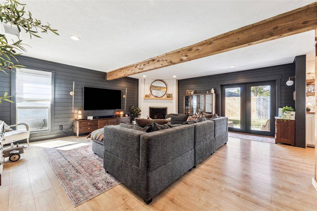 Large open living area with cozy brick fireplace.