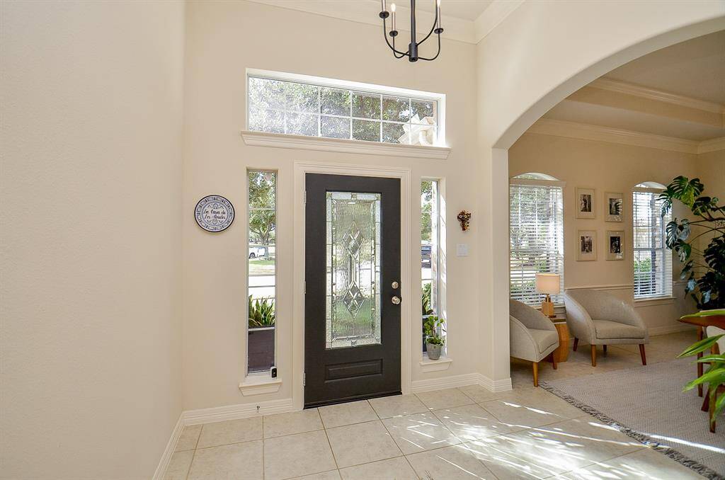 A transom window and sidelight windows as well as the inset glass panel bring light into the home.  This home is always filled with natural light, even on a cloudy day.  Perfect for your lovely plants.