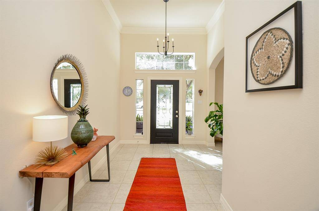 Here is the spacious entryway, large enough for a decorative table and your wall art.  To the right is the formal dining room.