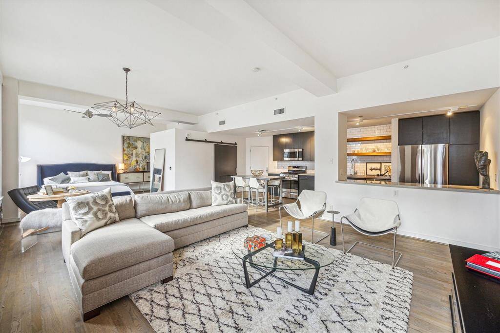 Another view facing the kitchen, bedroom, and living area in Bayou Lofts, capturing the open-concept design and spacious layout.