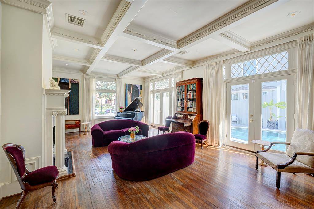 This view of the living room emphasizes the stunning classic windows, which brighten the space with abundant natural light. Framed by elegant and intricate millwork, the windows serve as a centerpiece, showcasing timeless craftsmanship.
